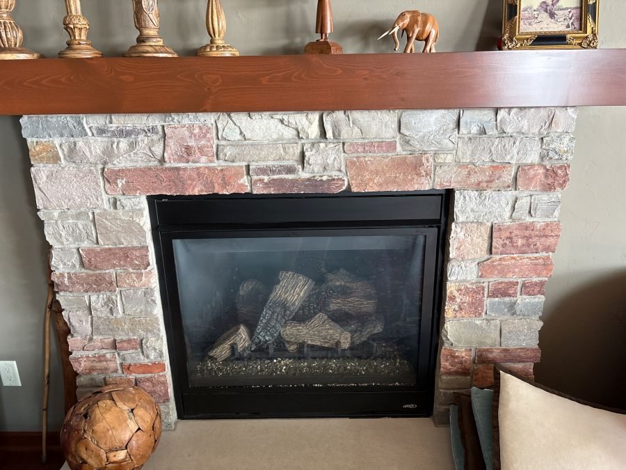 Solid wood mantel beam installed directly above a direct vent gas fireplace
